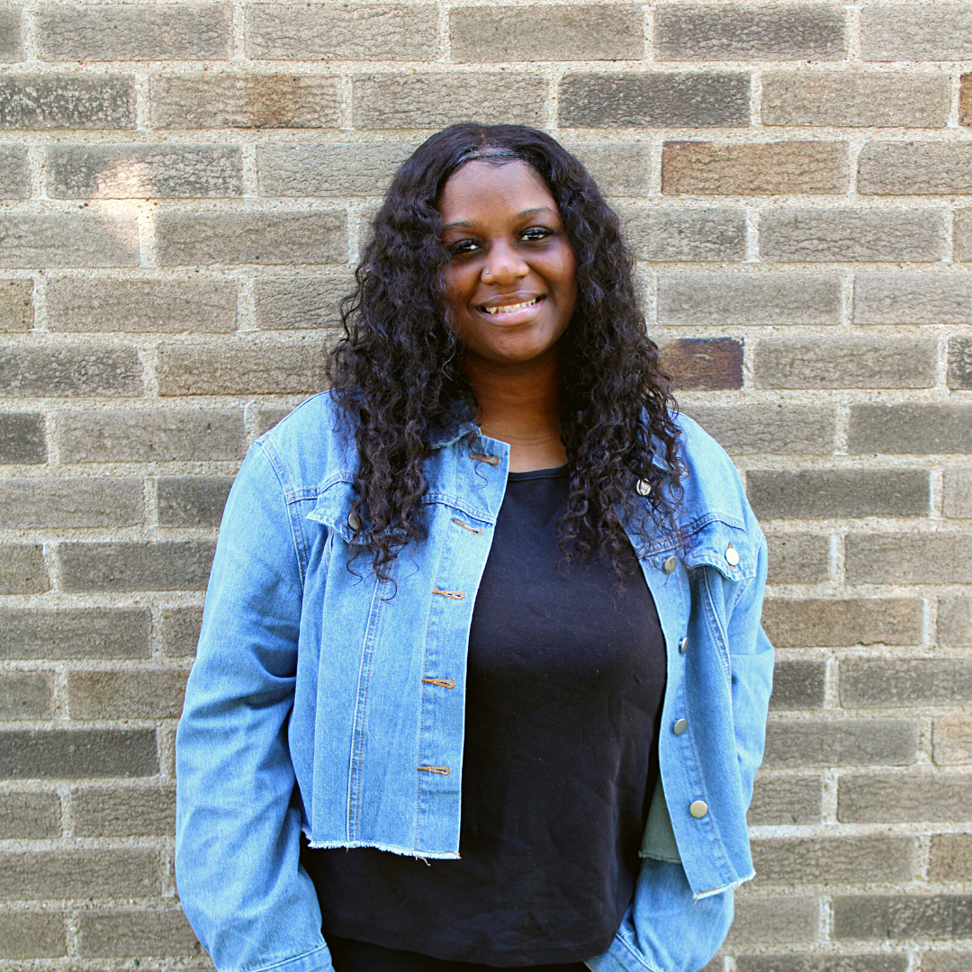 A photo of a high school Michigan charter school graduate, smiling. 