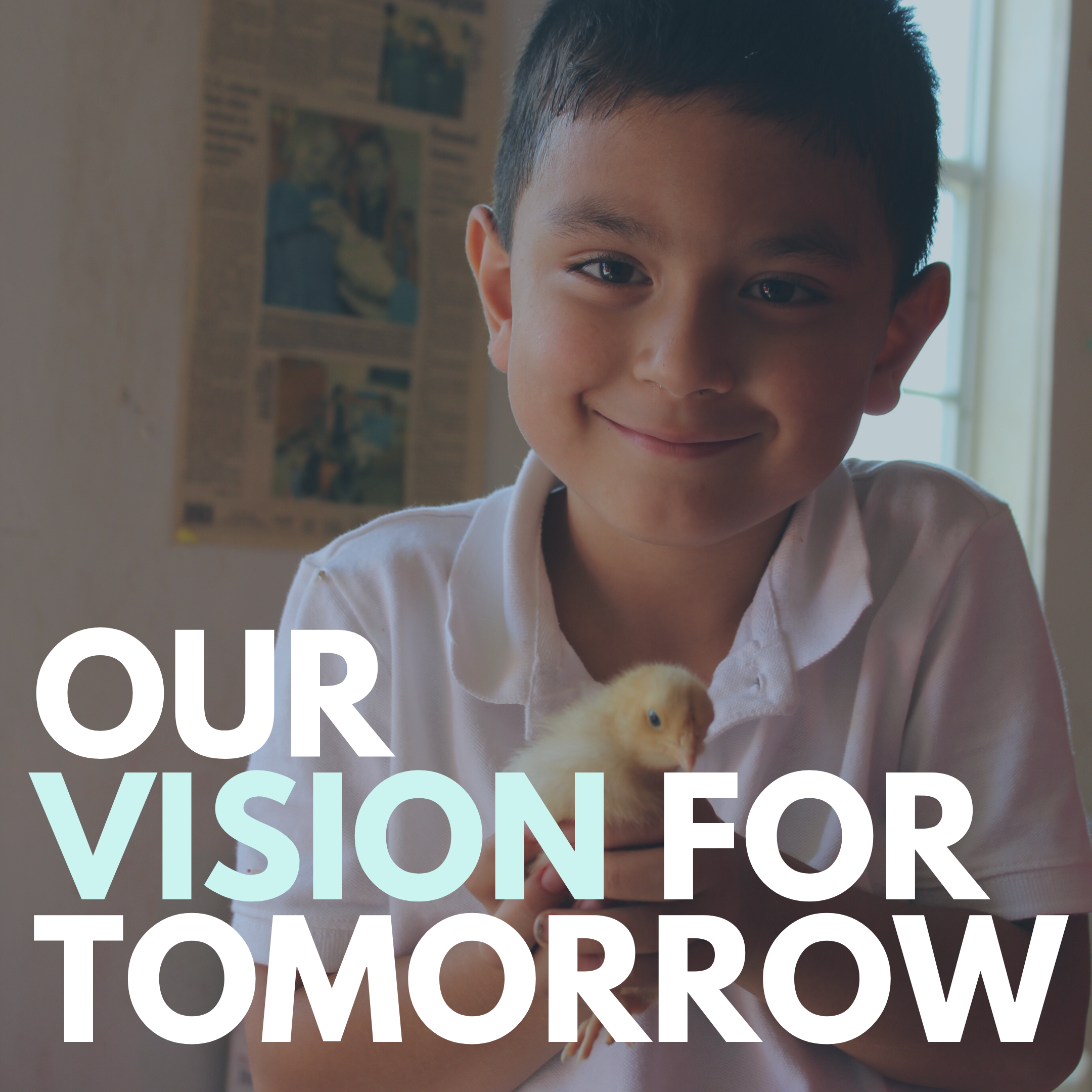 A photo of an elementary-aged Hispanic male student, holding a yellow baby chick and smiling for the camera.