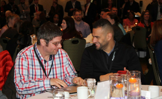 A photo of two charter professionals, talking during General Session at the 2017 Michigan Charter School Symposium. 