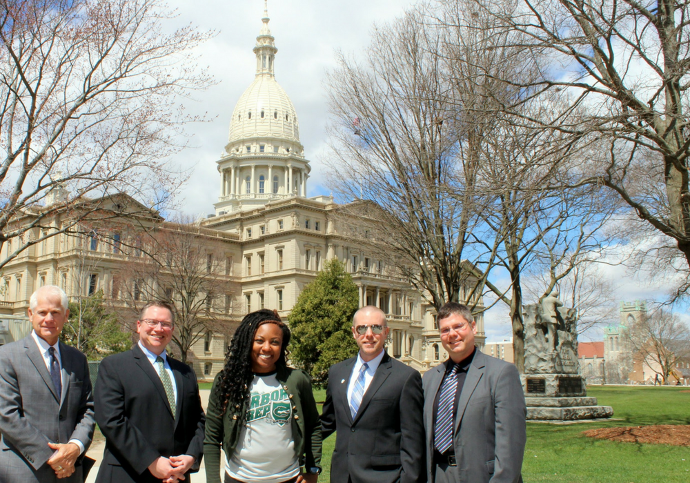 A photo of several charter school administrators in front of the Lansing, Michigan capitol building.