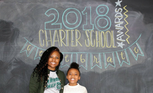 A photo o Aquan Grant, 2018 Charter School Admin of the Year finalist, and her daughter.
