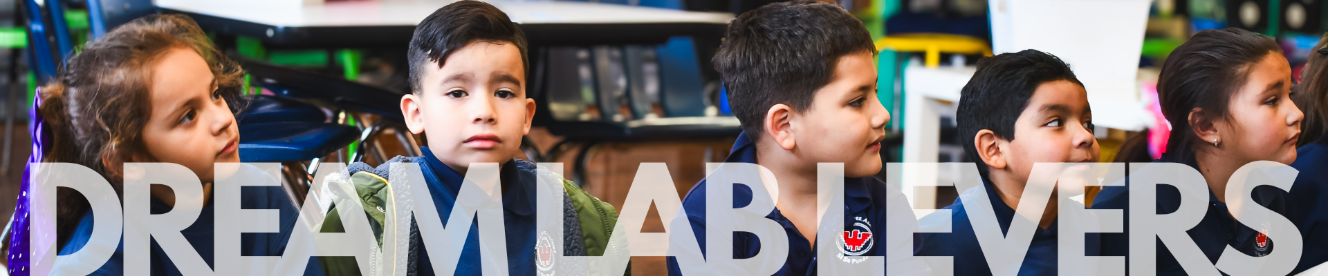 Elementary students sitting on the floor in a classroom