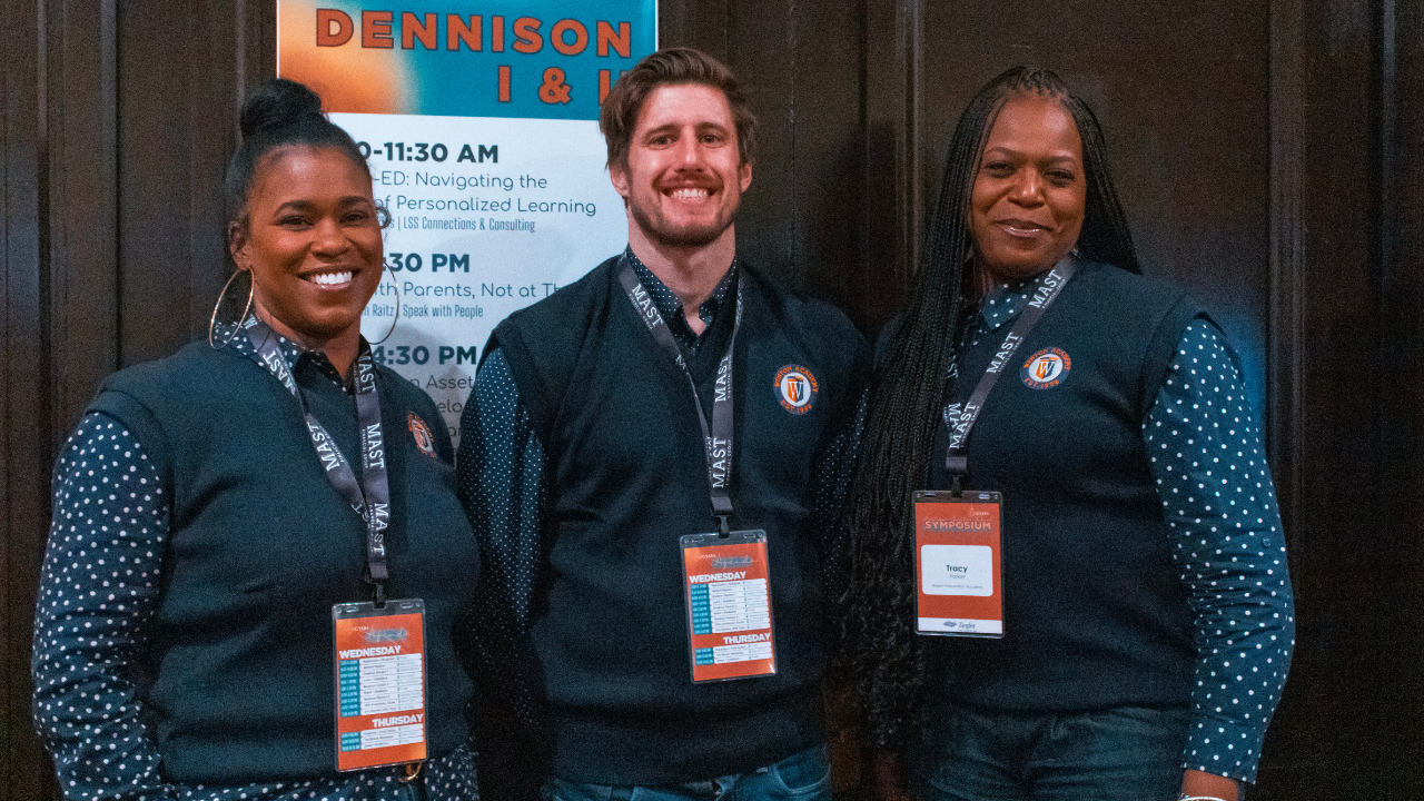 Attendees posing with their nametags
