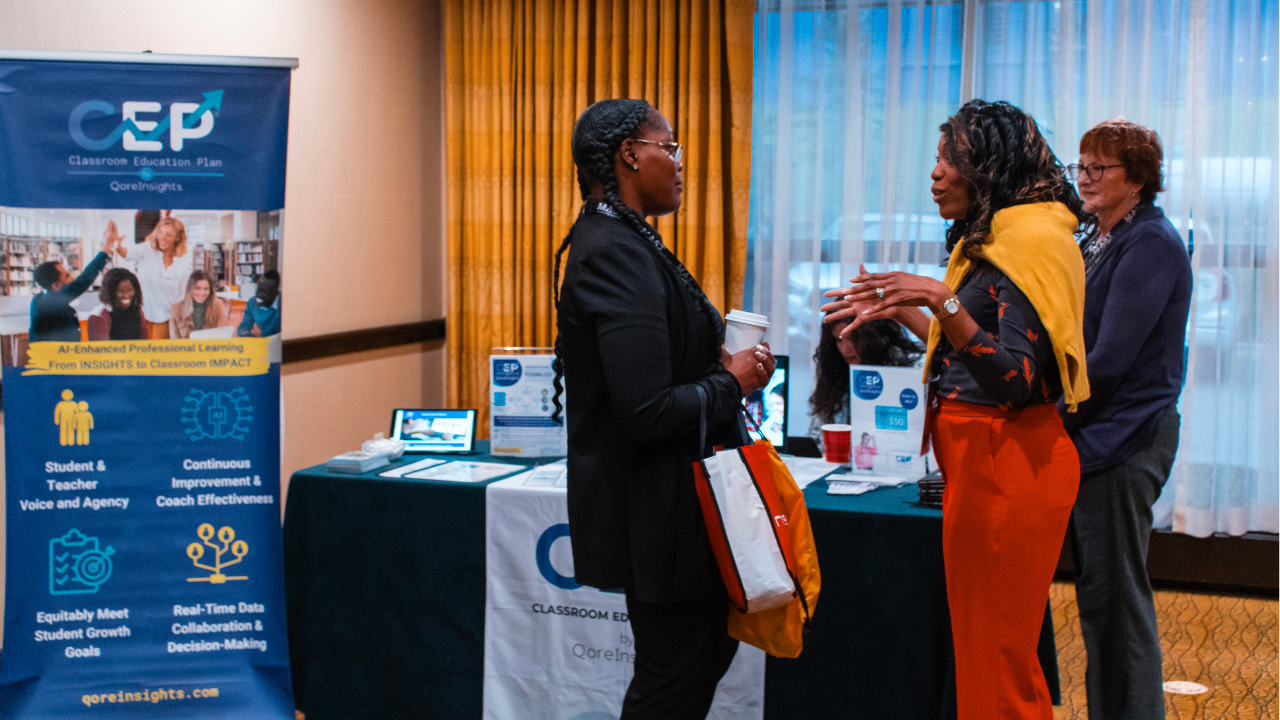 Attendees networking with an exhibitor at Symposium