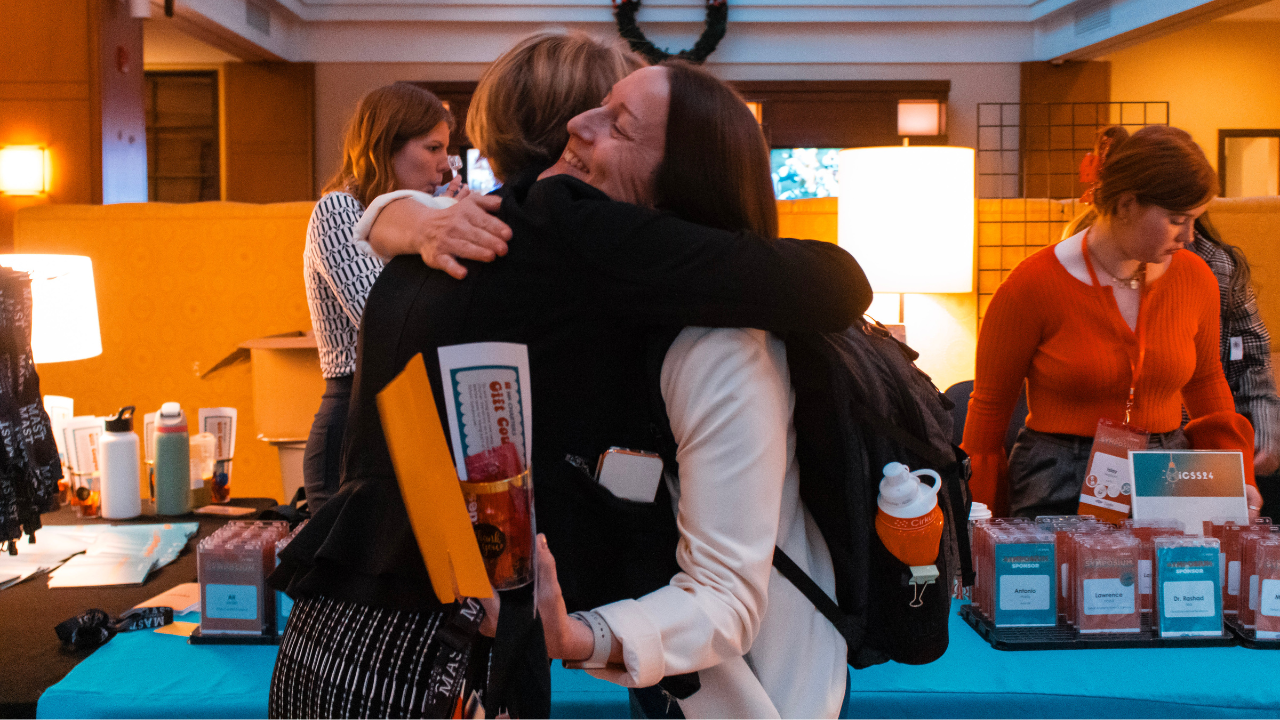 Attendees hugging at registration