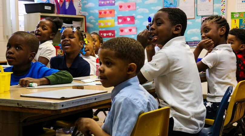 A photo of several elementary students sitting at their desks in a Martin Luther King Jr. Education Center Academy classroom. 