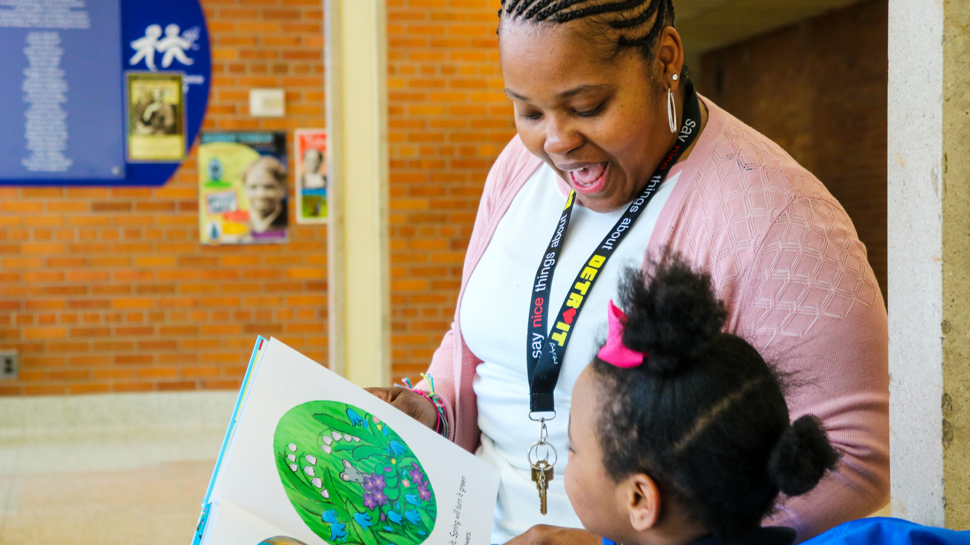 A photo of Distinctive College Prep special education teacher, Chrysantha Norwood, reading to an elementary student.