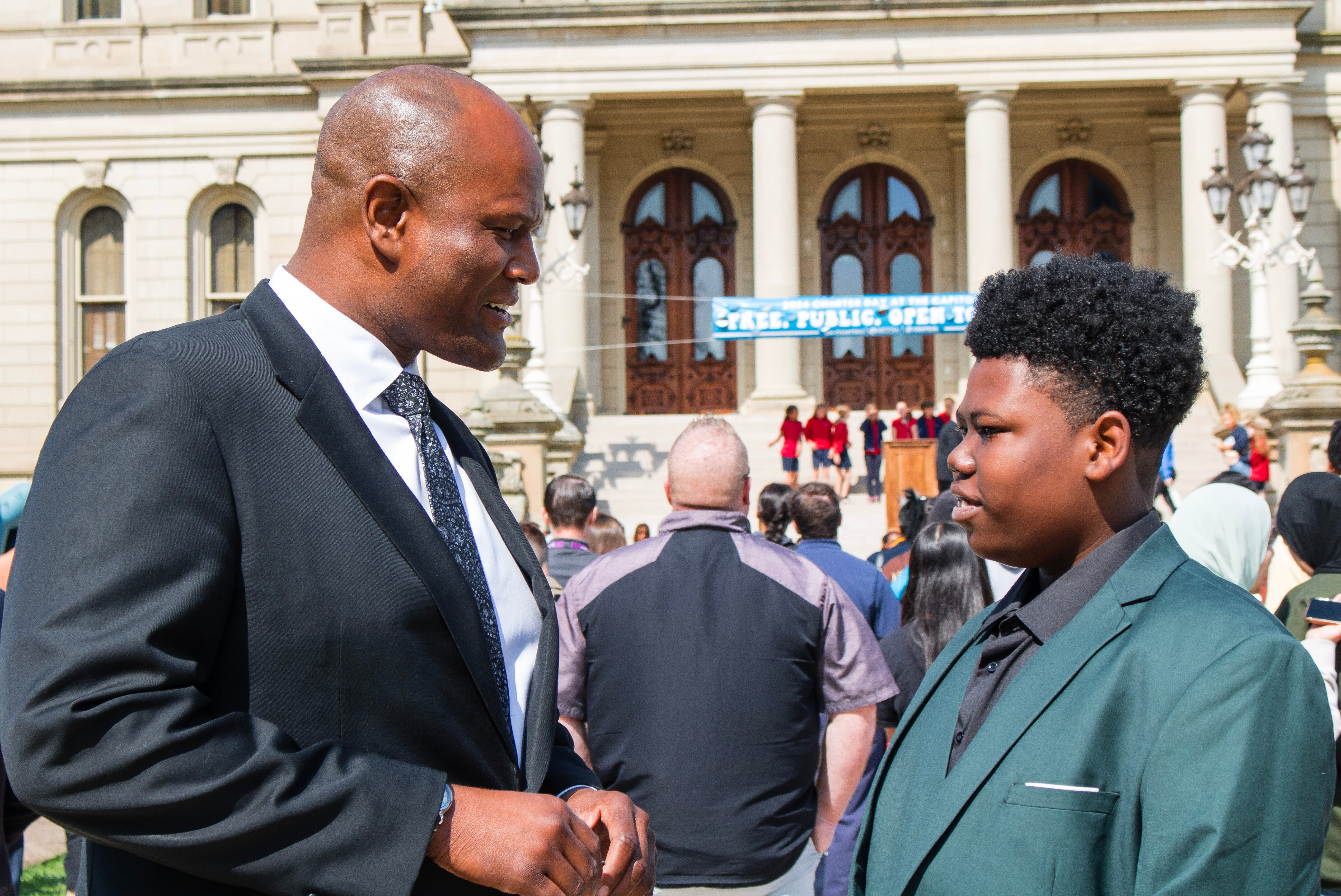Rep Joe Tate engaging with charter school student